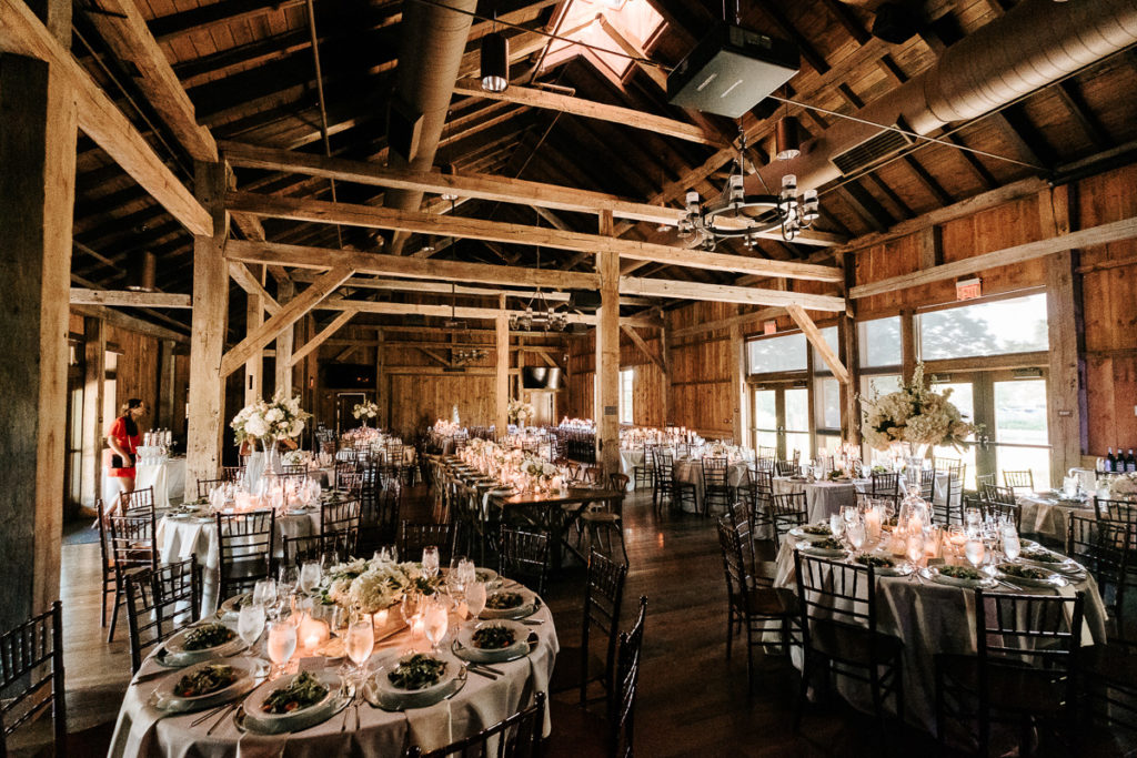 Beautiful wedding reception with tables and decor at the Wells Barn in Columbus.