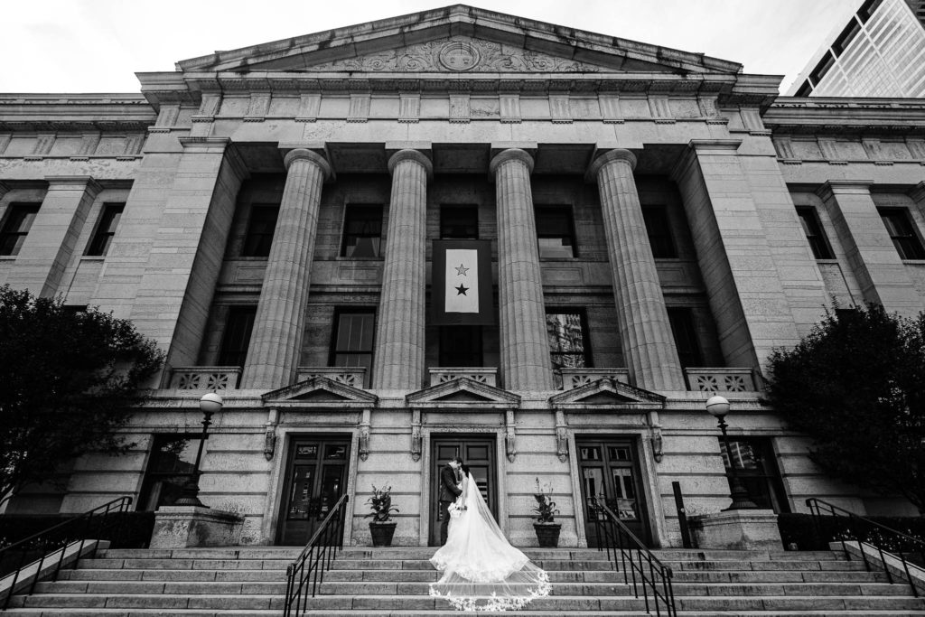 Bride and groom sharing a romantic moment at their wedding at the Ohio Statehouse. 