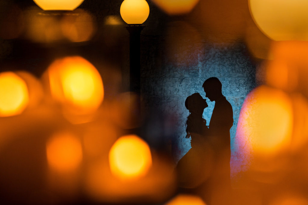 Candle lit silhouette of the couple at their wedding at the Ohio Statehouse.