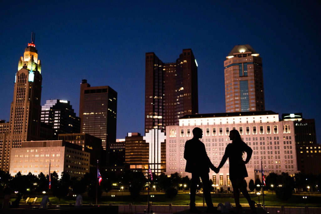 Couple holding hands at their night time engagement session at Genoa Park. Best Places to Propose in Columbus Ohio