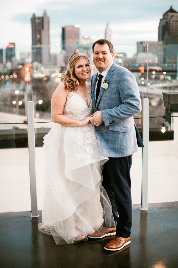 Couple at their wedding with the Columbus skyline in the background. North 4th Corridor, Revery venue.
