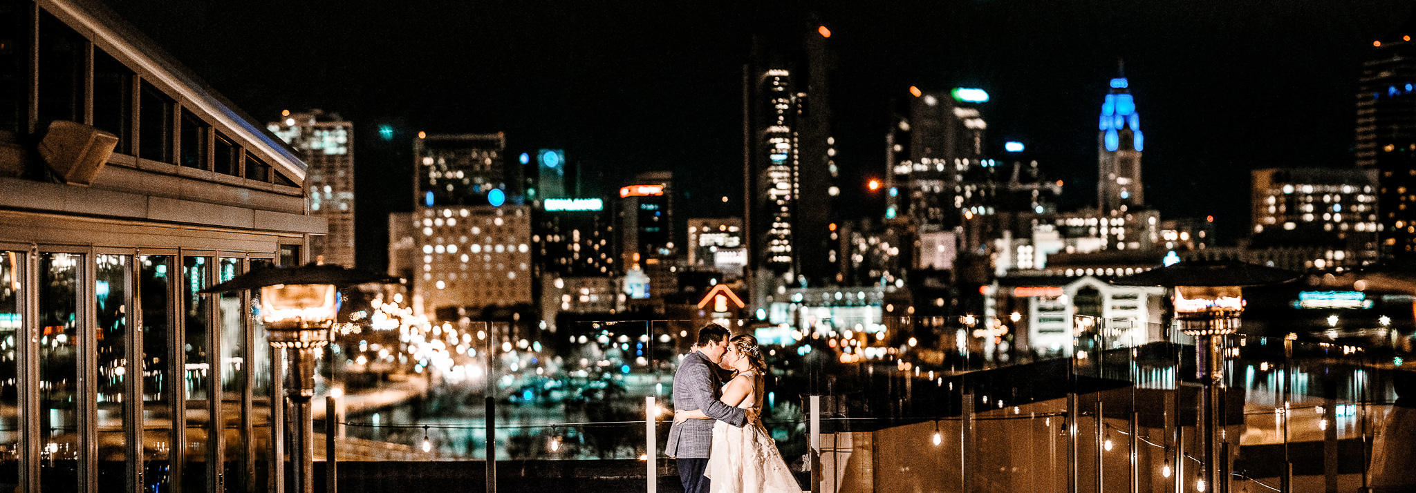 Couple at their wedding with the Columbus skyline at night in the background. North 4th Corridor, Revery venue.