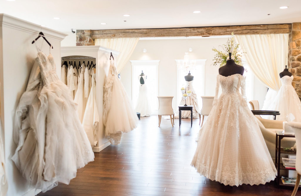 Photograph of the inside of White of Dublin. Dresses are showing on mannequins.  