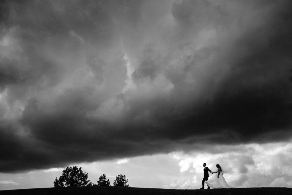 Just married couple walking on the gold course at Wedgewood in Columbus, dramatic photograph. 