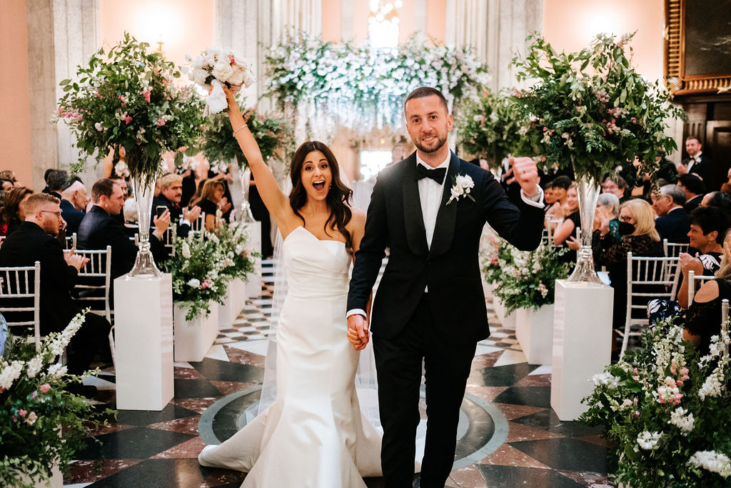 Bride and Groom Walking down Isle celebrating after getting married.