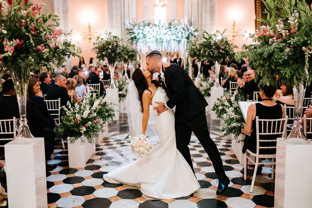 Couple kissing during Processional after wedding at Ohio Statehouse rotunda.
