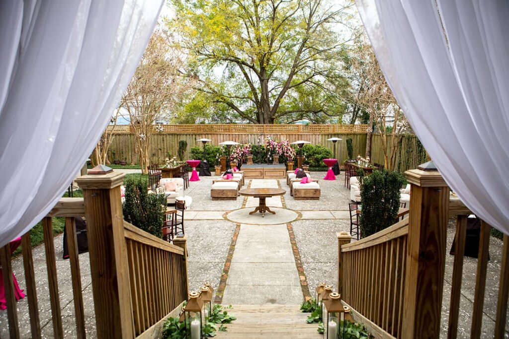 Brooklyn Arts Center Outside Reception area with sheer fabric flanking the patio and the courtyard has furniture places for guest.