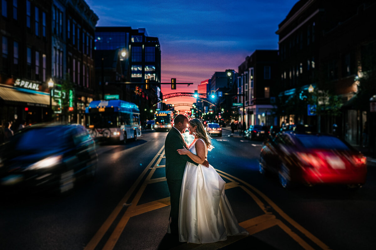 Storyteller Adams couple in the city streets wedding photo with city lights and buildings.