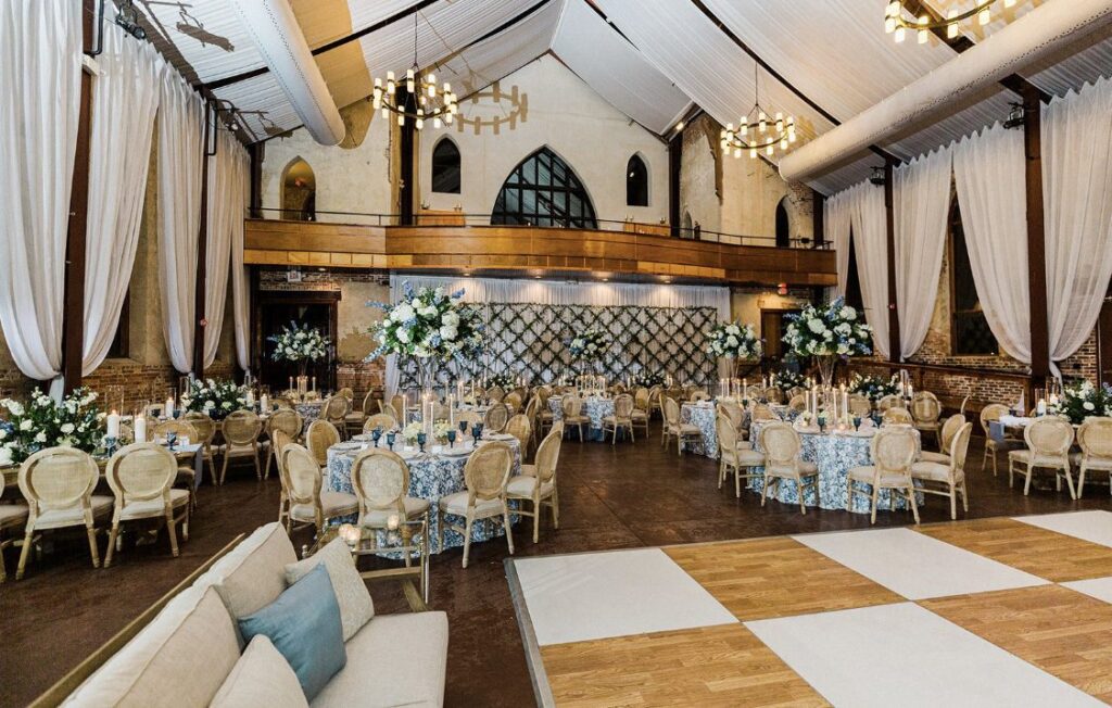 Brooklyn Arts Center reception area decorated with round tables and dance floor with checkered pattern.