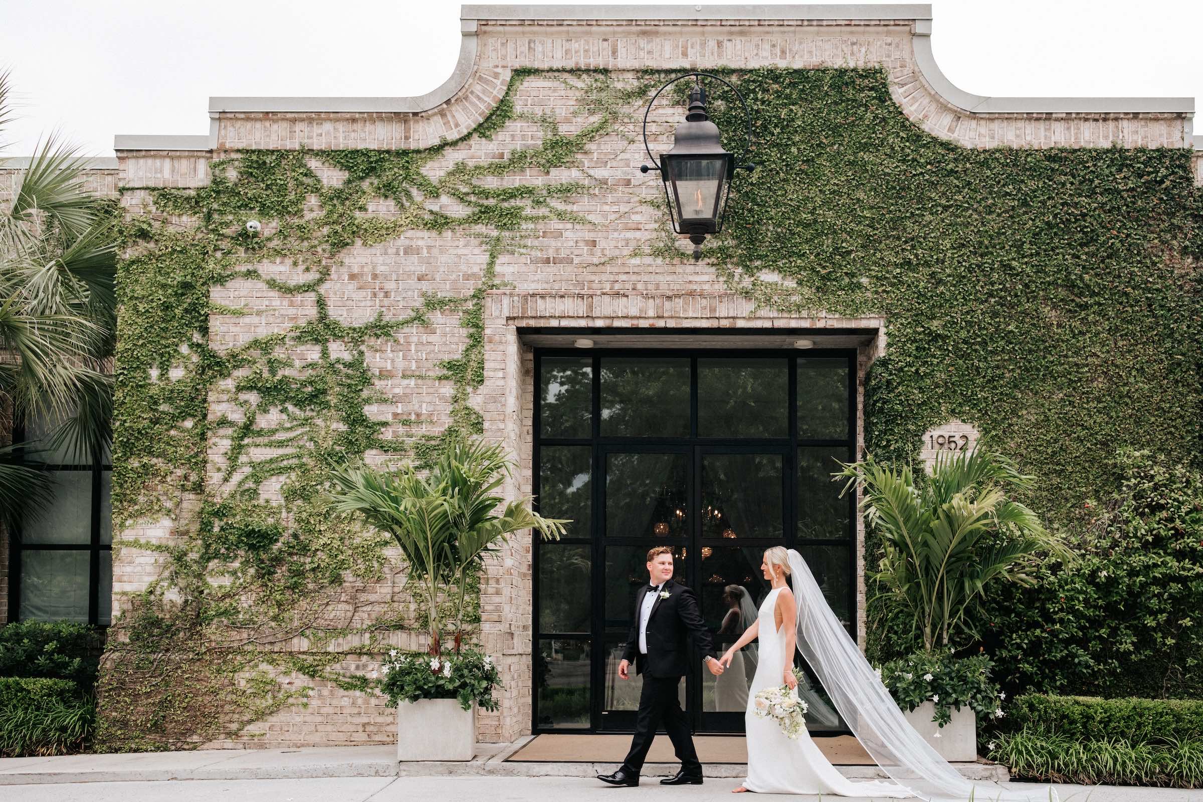 Couple walking holding hands at their wedding in Wilmington at the Wrightsville Manor.